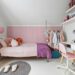 A child's bedroom with a bed, desk, and chair