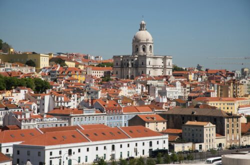 a view of a city with a church in the background